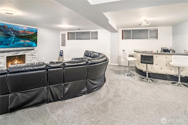 home theater with baseboards, speckled floor, electric panel, a fireplace, and a textured ceiling