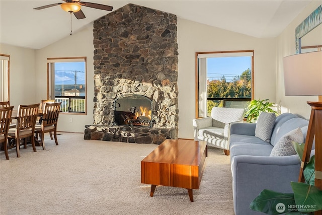 living room featuring vaulted ceiling, plenty of natural light, carpet floors, and ceiling fan