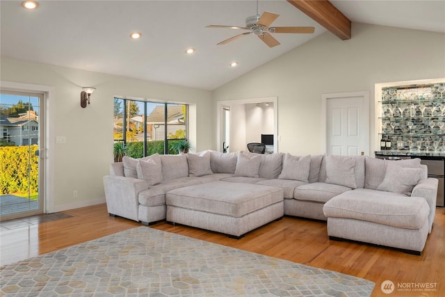 living area with beamed ceiling, recessed lighting, a ceiling fan, and wood finished floors