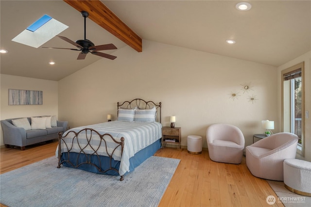 bedroom with ceiling fan, vaulted ceiling with skylight, wood finished floors, and recessed lighting