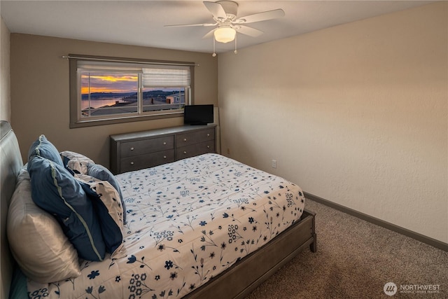 carpeted bedroom featuring baseboards and a ceiling fan