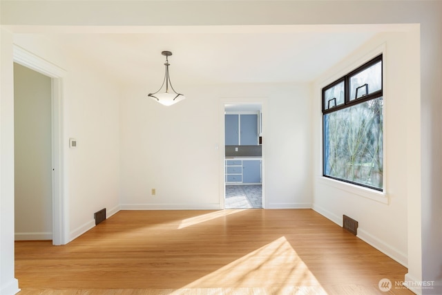 unfurnished room featuring light wood-style flooring and baseboards