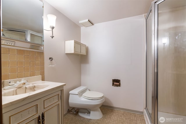 full bathroom featuring vanity, toilet, a shower stall, and tile patterned flooring