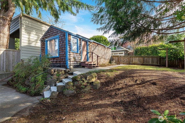 exterior space featuring entry steps and fence