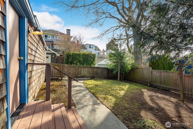 view of yard featuring a fenced backyard and a residential view