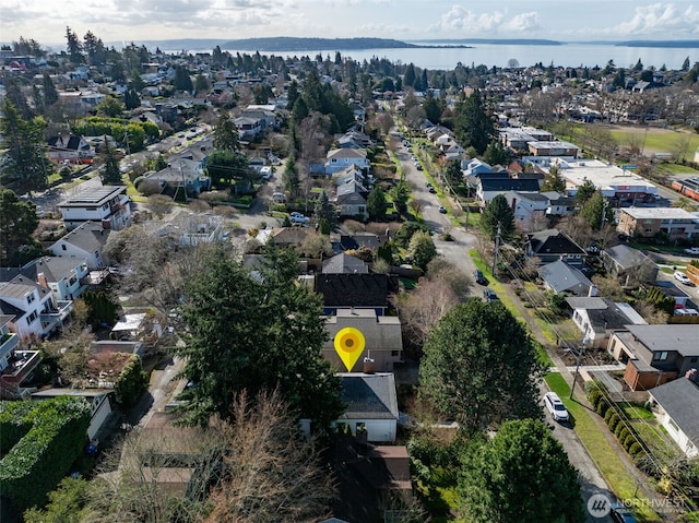 drone / aerial view with a residential view and a water view