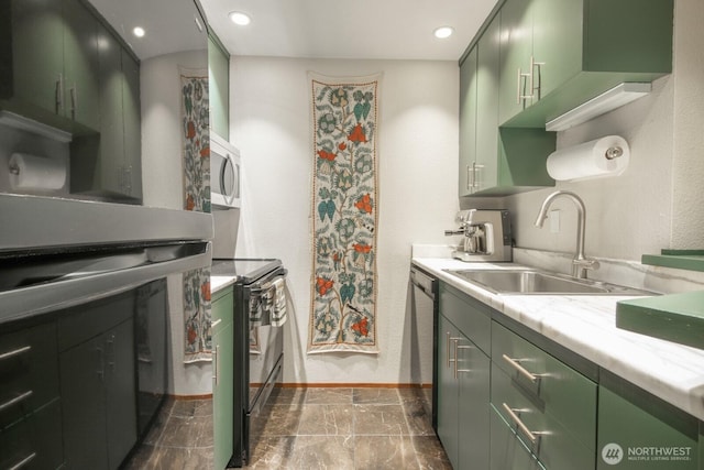 kitchen featuring green cabinetry, baseboards, black range with electric cooktop, and a sink