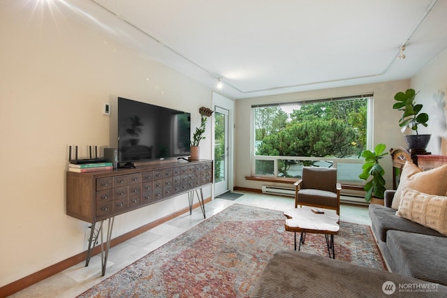 tiled living area with a baseboard radiator, baseboards, and rail lighting