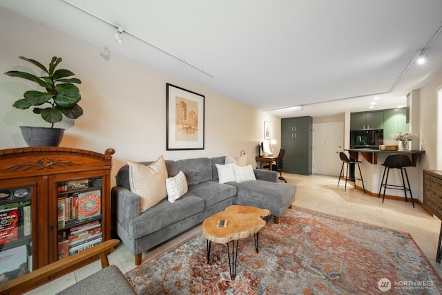 living room featuring light tile patterned floors and rail lighting