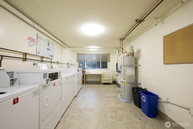 shared laundry area with washer and dryer, light floors, a textured ceiling, and secured water heater