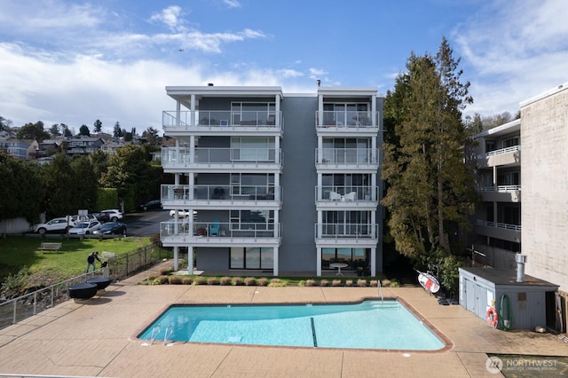 community pool featuring a patio area and fence