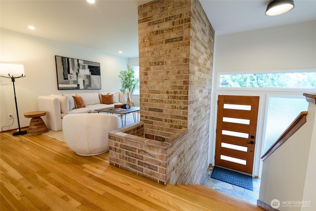 living area with plenty of natural light, recessed lighting, and wood finished floors