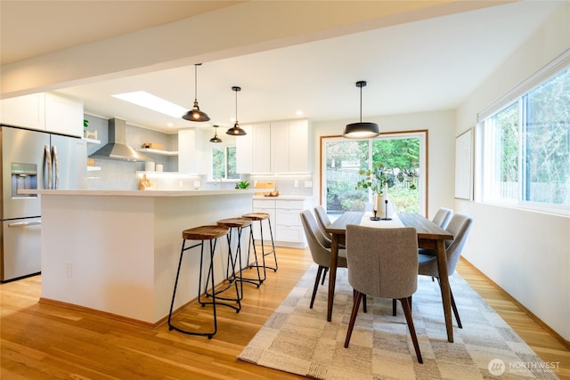 dining room with recessed lighting and light wood-type flooring