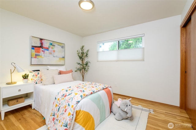 bedroom featuring a closet and light wood-style flooring