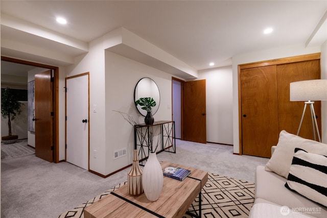 living area featuring light carpet, visible vents, recessed lighting, and baseboards