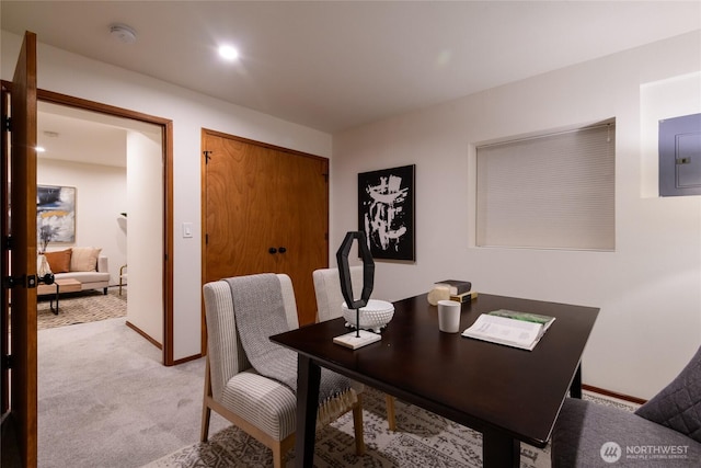 dining room with recessed lighting, electric panel, light colored carpet, and baseboards