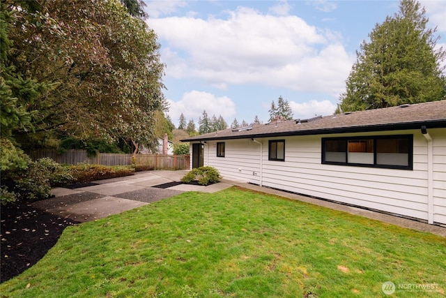 back of house featuring a patio, fence, and a lawn