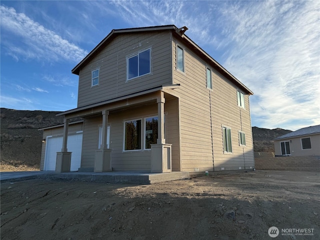 view of front of property featuring a mountain view and a garage