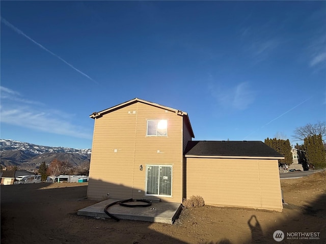 rear view of property with a mountain view