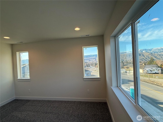 spare room with recessed lighting, visible vents, baseboards, and dark carpet