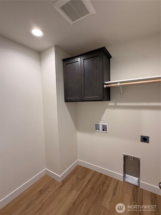 clothes washing area featuring hookup for a washing machine, baseboards, visible vents, hookup for an electric dryer, and light wood-type flooring