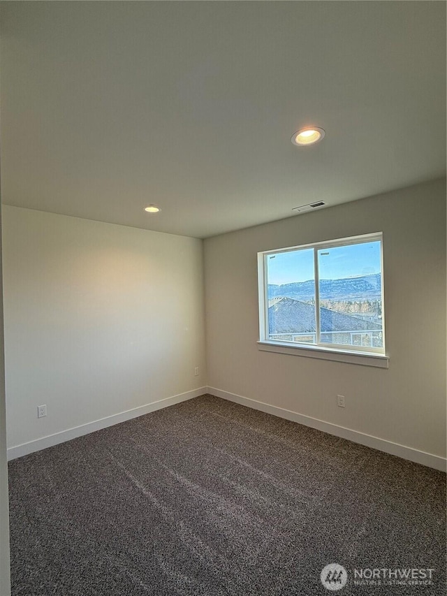 unfurnished room featuring recessed lighting, visible vents, dark carpet, and baseboards