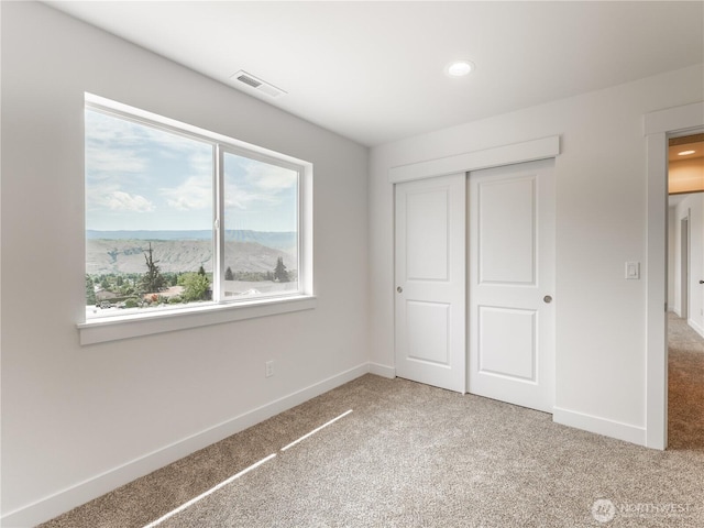 859 N Lyle Ave, East Wenatchee, WA 98802 - unfurnished bedroom featuring light carpet, a closet, and recessed lighting