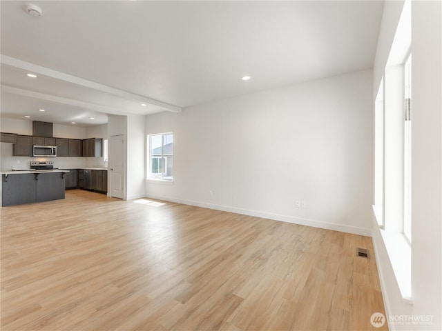 859 N Lyle Ave, East Wenatchee, WA 98802 - unfurnished living room with light wood finished floors, recessed lighting, and beamed ceiling