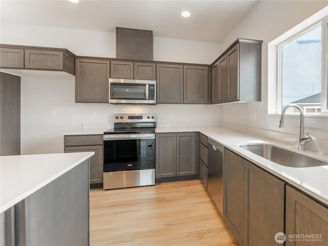 859 N Lyle Ave, East Wenatchee, WA 98802 - kitchen featuring stainless steel appliances, light wood finished floors, light countertops, recessed lighting, and dark brown cabinets