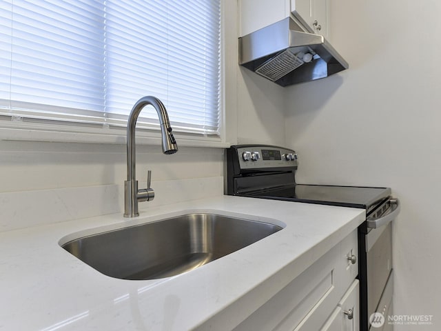 details with light stone countertops, stainless steel electric stove, a sink, white cabinets, and under cabinet range hood