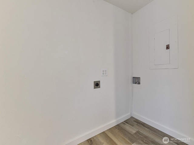 washroom with electric dryer hookup, washer hookup, wood finished floors, baseboards, and laundry area