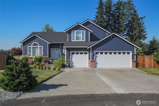 view of front facade with brick siding, an attached garage, concrete driveway, and fence