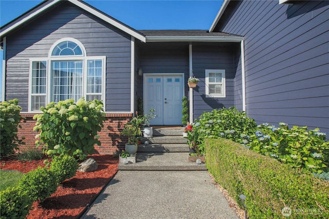 property entrance with brick siding