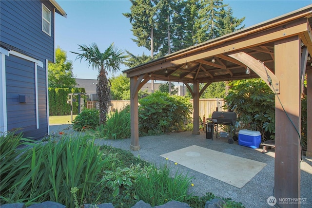 view of patio with a gazebo, fence, and grilling area