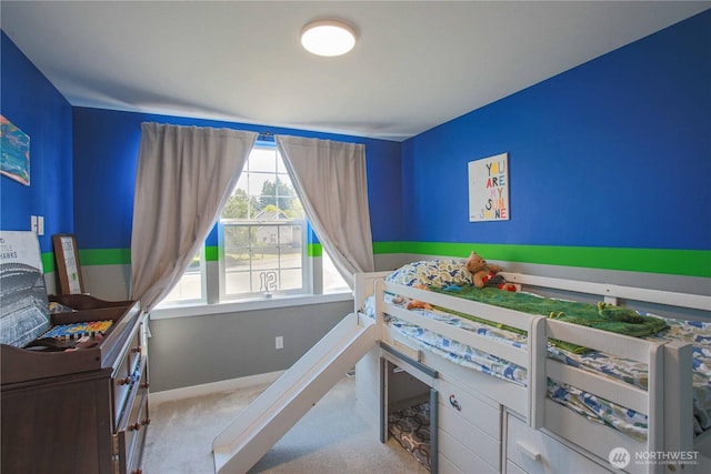 carpeted bedroom featuring baseboards