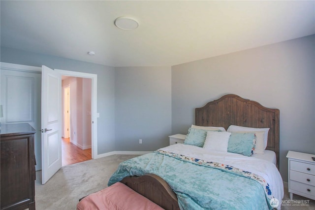 bedroom featuring baseboards and light carpet