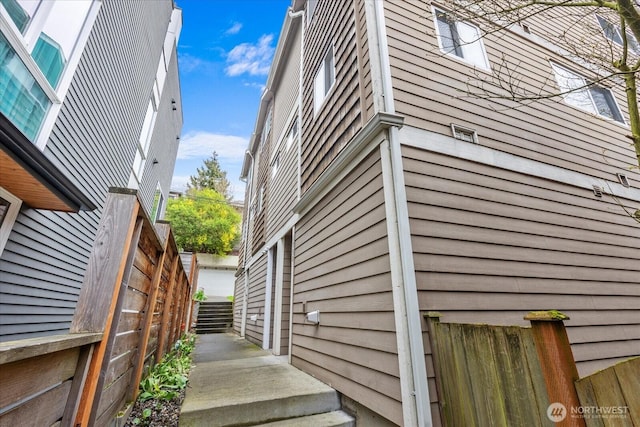 view of home's exterior with fence