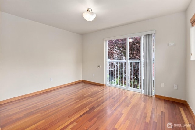 empty room featuring baseboards and wood finished floors