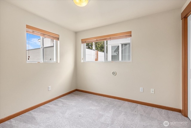 empty room with carpet flooring and baseboards