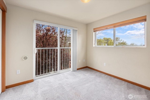 empty room with carpet flooring and baseboards