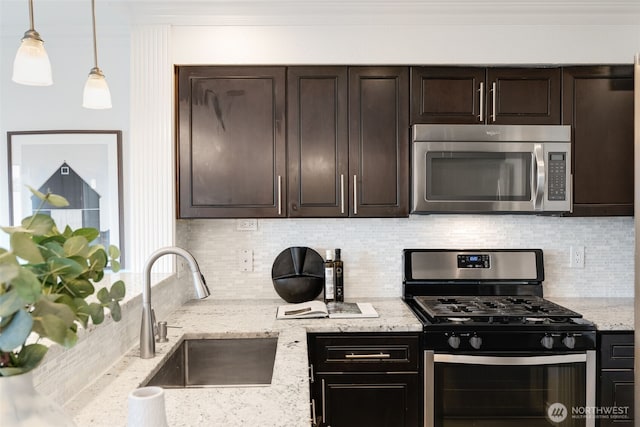 kitchen featuring a sink, stainless steel appliances, dark brown cabinetry, and ornamental molding