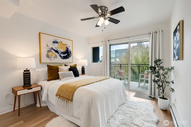 bedroom with a ceiling fan, access to outside, light wood-style floors, a baseboard radiator, and baseboards