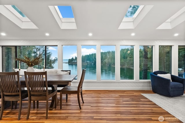 sunroom with vaulted ceiling with skylight