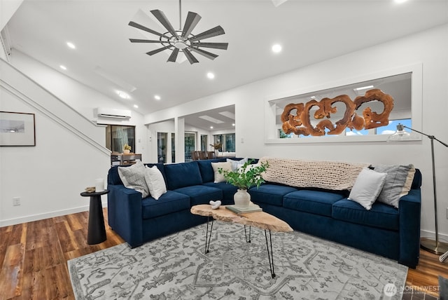 living room featuring vaulted ceiling, a wall mounted air conditioner, ceiling fan, and wood finished floors