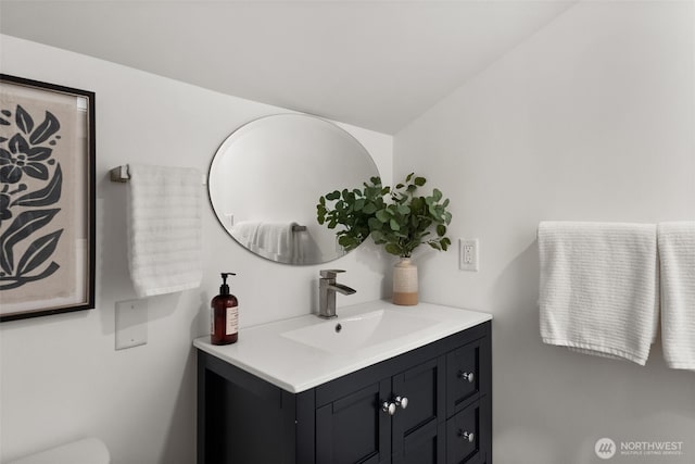 bathroom featuring vanity and toilet