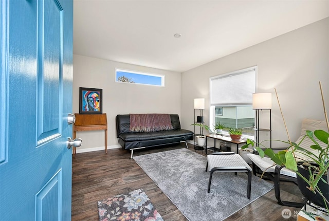 interior space with baseboards and dark wood-style floors