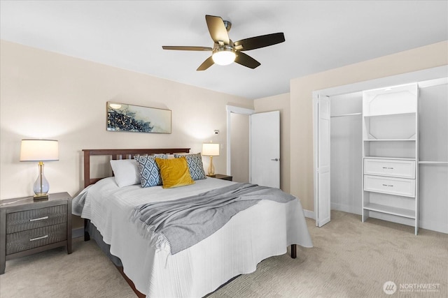 bedroom featuring a closet, light colored carpet, baseboards, and a ceiling fan