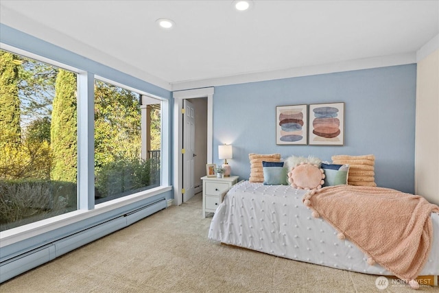 bedroom with recessed lighting, baseboard heating, and carpet