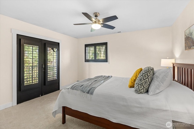 carpeted bedroom with access to exterior, visible vents, french doors, and a ceiling fan