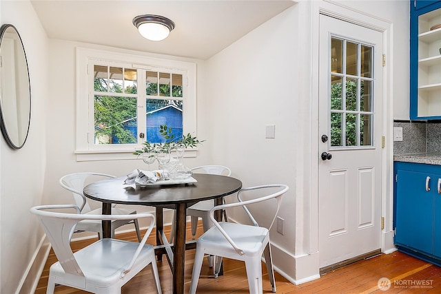 dining room with baseboards and wood finished floors